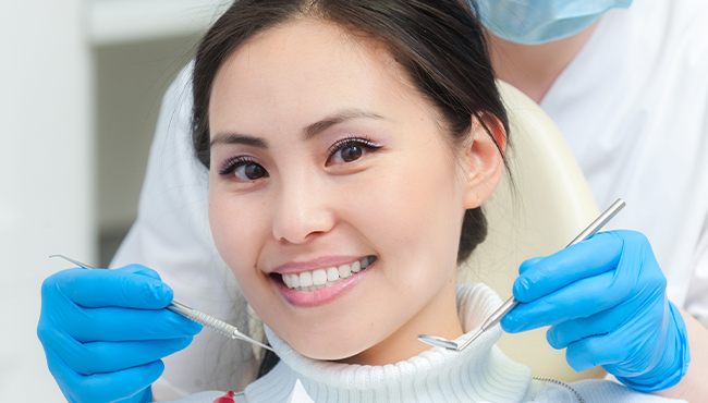 Woman receiving preventive dentistry to avoid dental emergencies