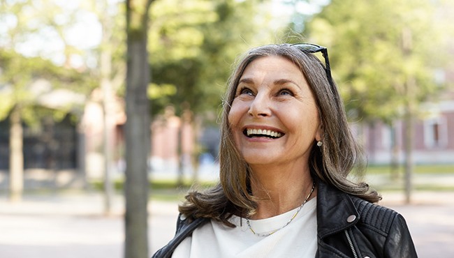 Senior woman walking outside smiling