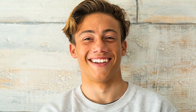 Male teenager smiling with damage-free teeth