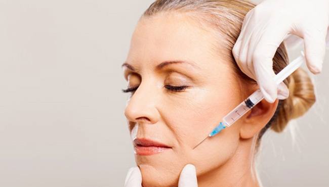 a woman receiving BOTOX injections for TMJ treatment