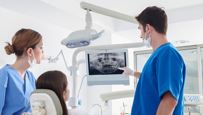 dentist showing a patient their dental X-rays