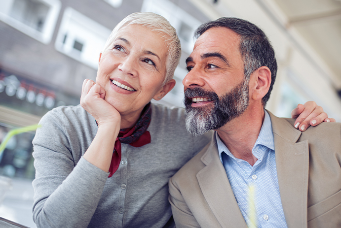 Older man and woman with flawless smiles after cosmetic dentistry