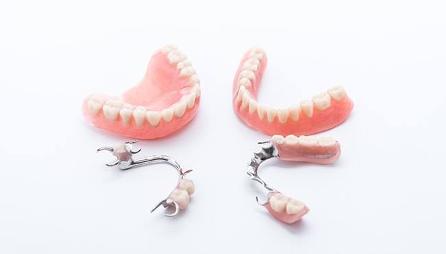 Different sets of dentures against a white background