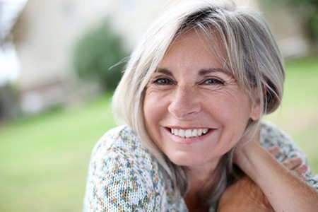 a woman smiling with new dentures