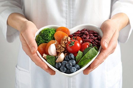 a person holding a bowl of healthy food