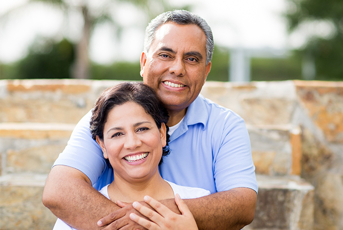 Man and woman sharing healthy smiles after emergency dentistry