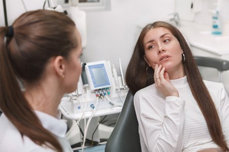 Woman with tooth pain visiting emergency dentist in Fort Worth, TX