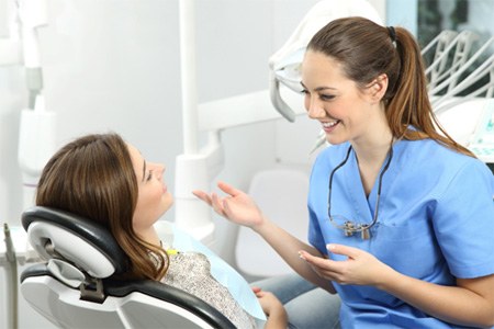 a dentist explaining the cost of tooth extractions 