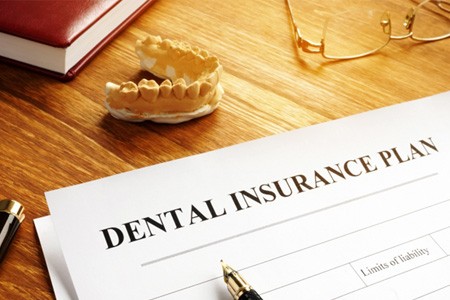 a dental insurance form on a wooden table 