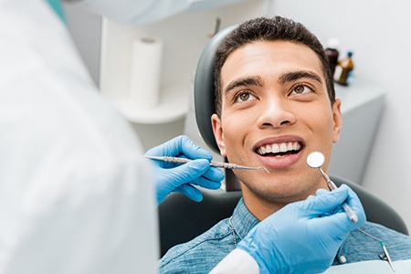 a person having their teeth cleaned by a dental hygienist