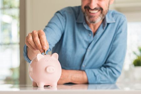 a man saving money in a piggy bank