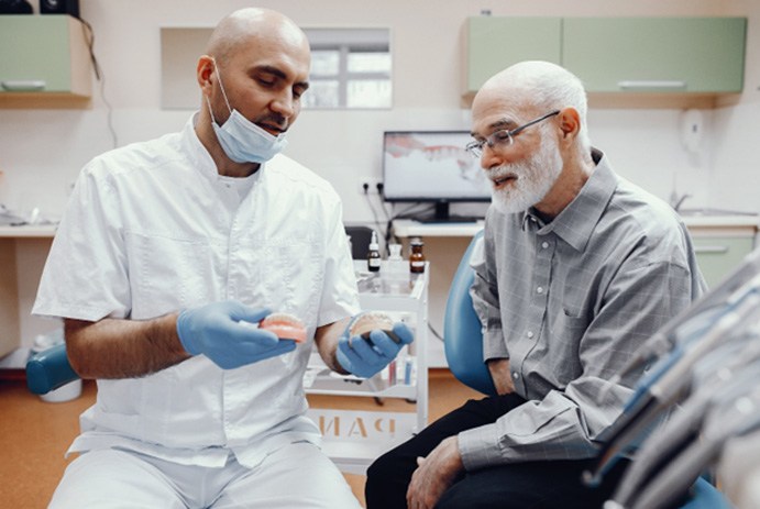 Man learning about implant dentures in Fort Worth