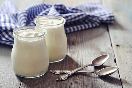 Close-up of yogurt next to two spoons