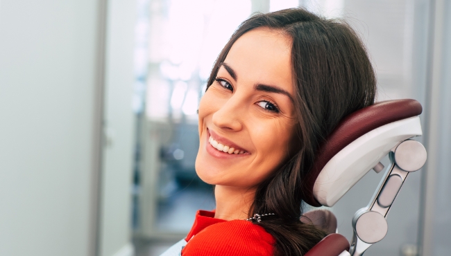 Woman smiling after dental implant tooth replacement