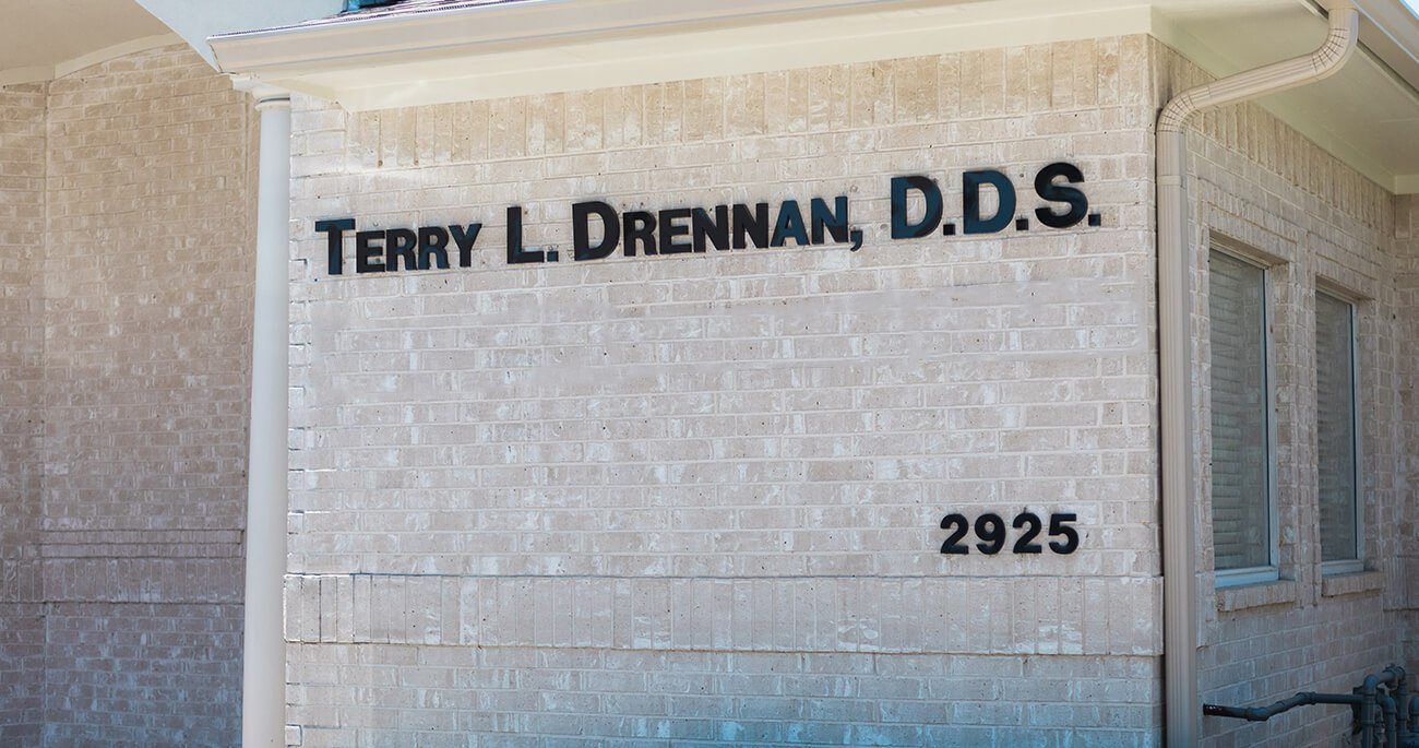 Sign saying Terry L Drennan D D S on dental office building exterior in Fort Worth