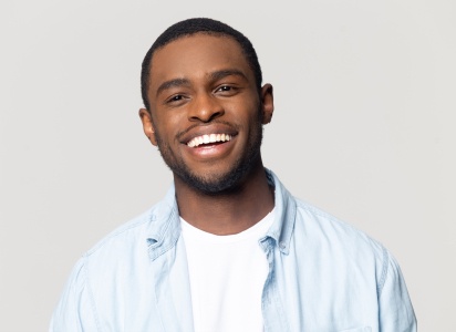 Man in light blue shirt smiling