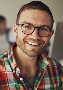 man with glasses smiling in the TCU area