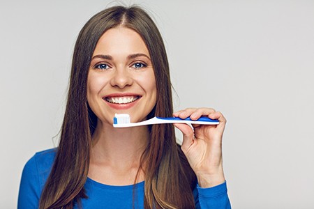 a patient brushing their teeth in Fort Worth