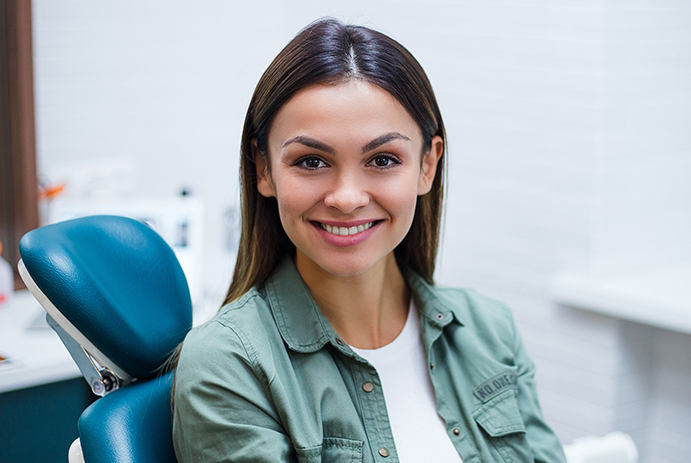 Woman smiling during preventive dentistry treatment