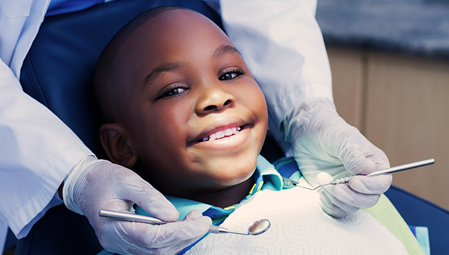 Young boy smiling during children's dentistry visit
