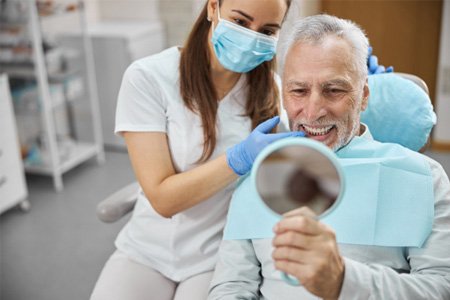 man smiling after getting dental implants