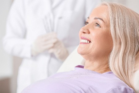 woman smiling after getting dental implants 