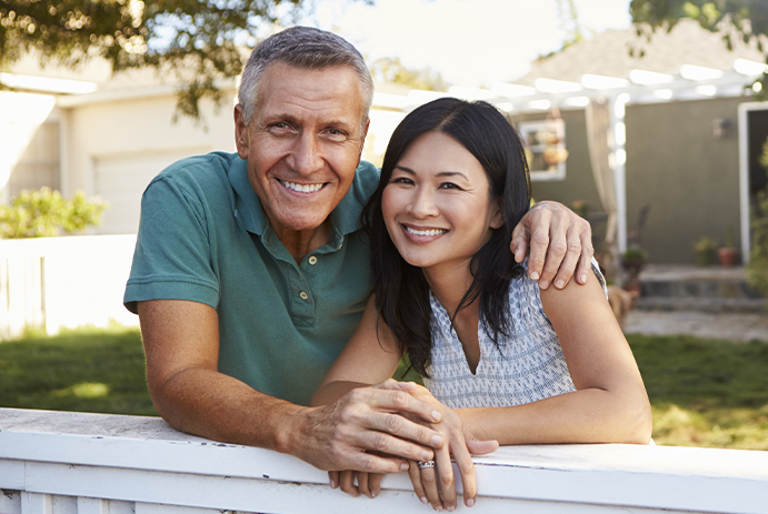 Man and woman smiling after restorative dentistry