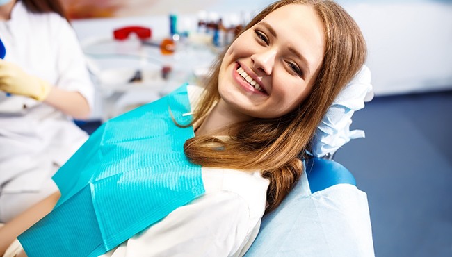 Woman smiling after getting a root canal in Fort Worth