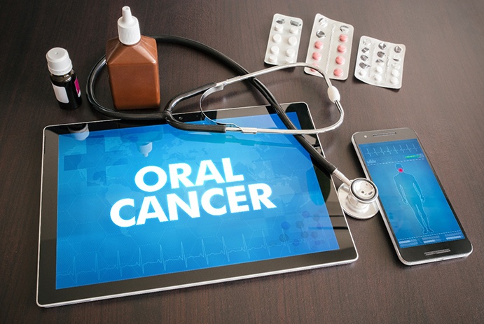 A tablet that says oral cancer and testing supplies