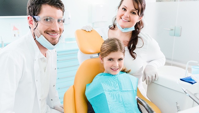 Young girl smiling in the dentist’s chair