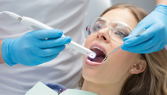 Dentist using intraoral camera to capture images