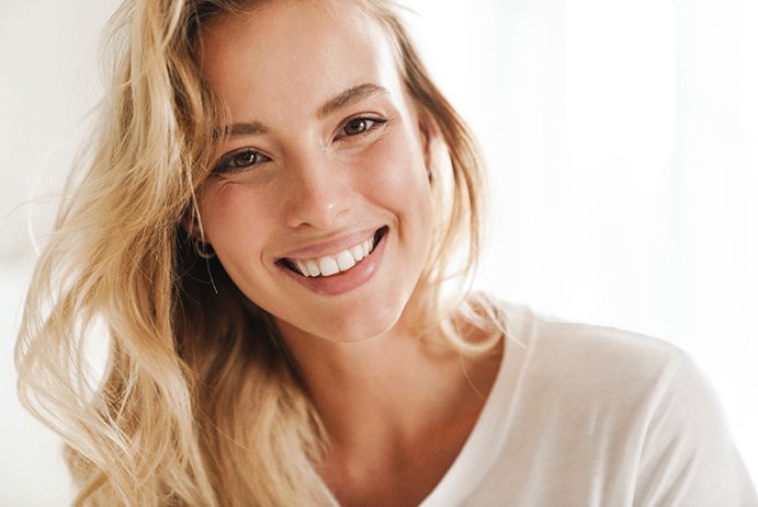 Closeup of woman with straight, white teeth smiling