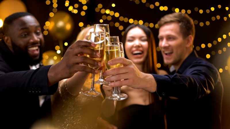 friends clinking champagne at event