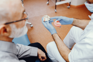 a patient chatting with their dentist about dentures