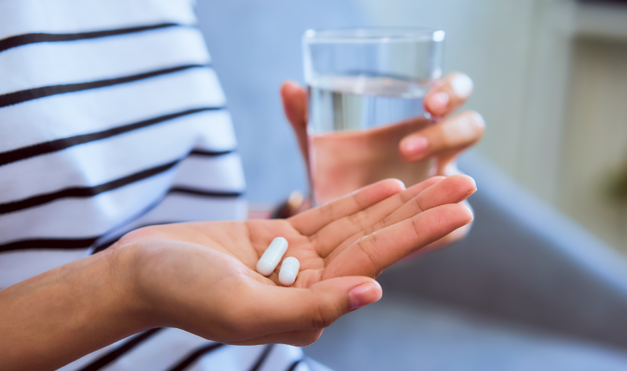 Woman holding pills