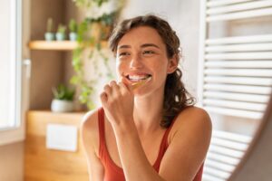 Woman brushing her teeth.